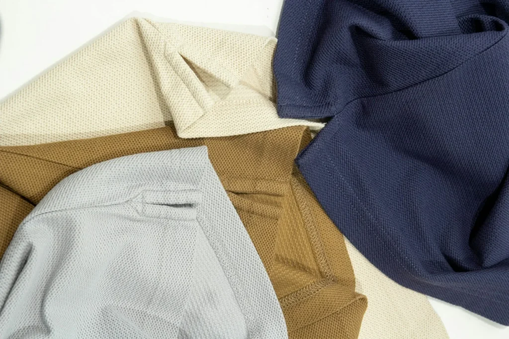 Four pieces laid out together in cream, caramel, grey and navy